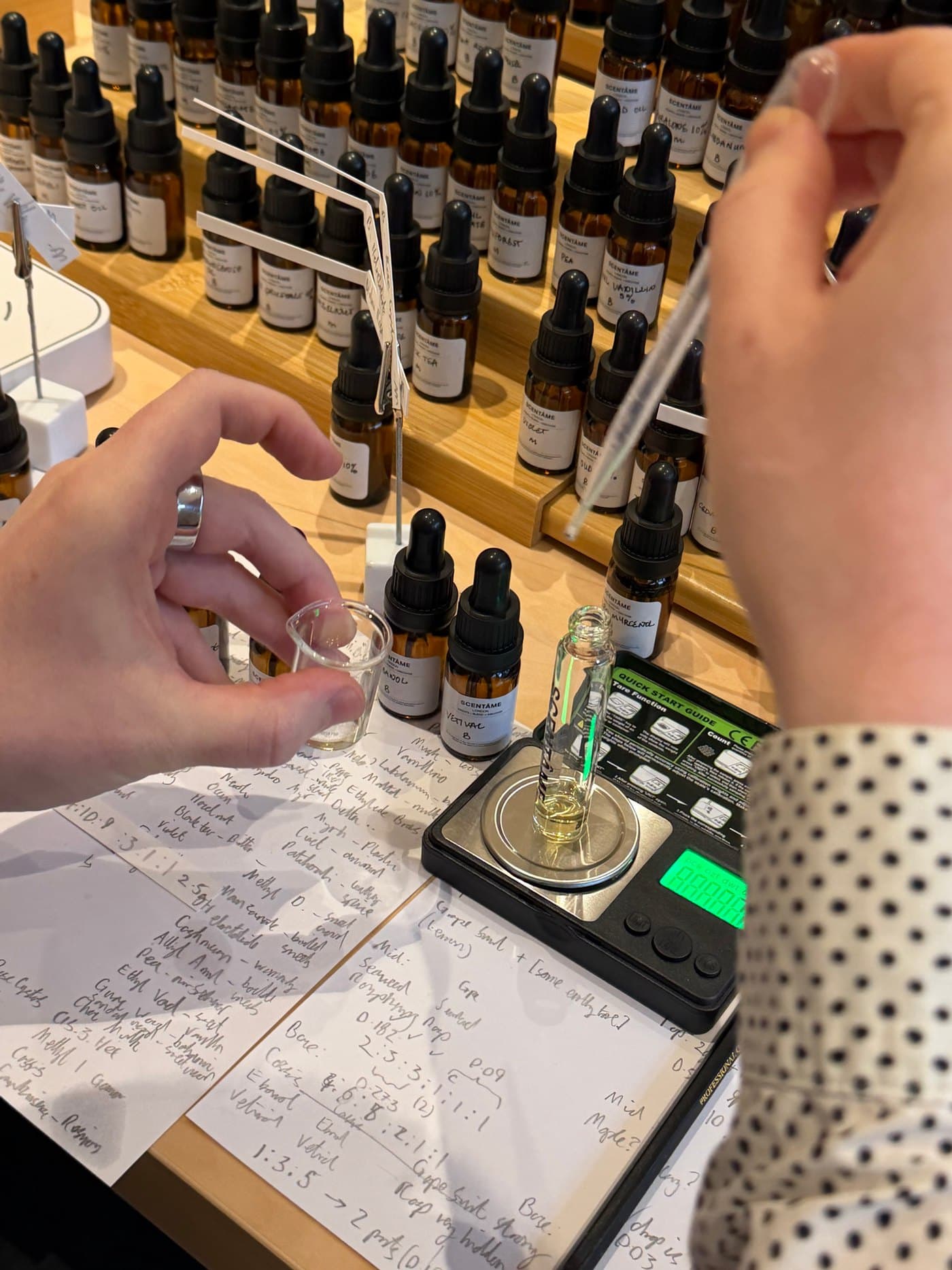 Weighing a perfume formula at the bench